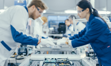 Electronics Factory Workers Assembling Circuit Boards